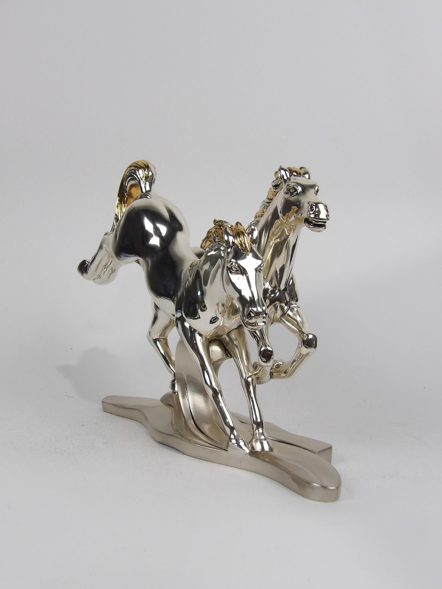 Silver & gold-coated resin sculpture “pair of running horses