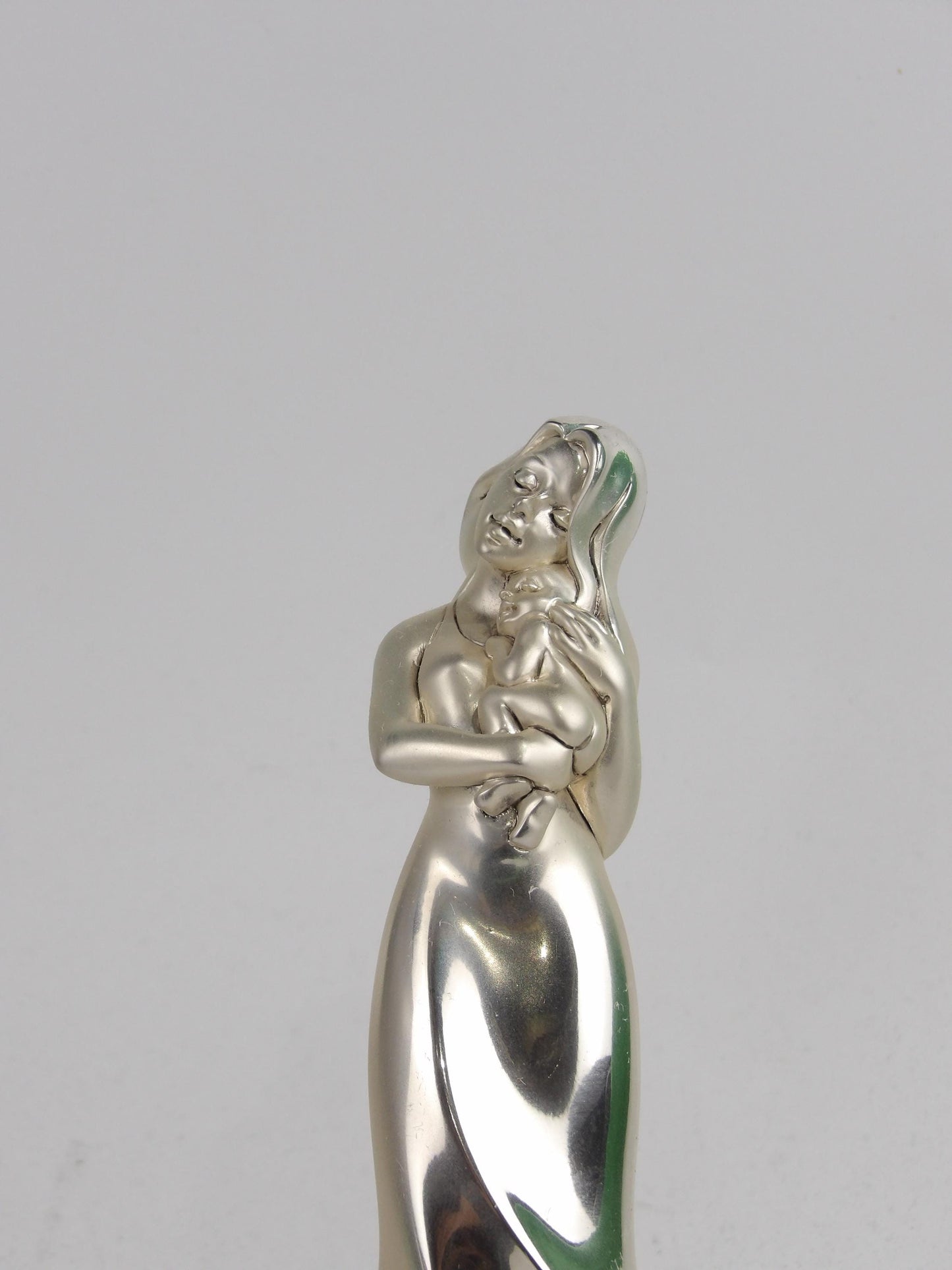 Silver Resin Sculpture subject "woman holding a baby"