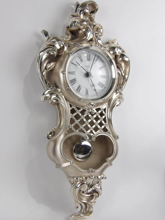 Elegante reloj de pared de péndulo de resina plateada: diseño ornamental.
